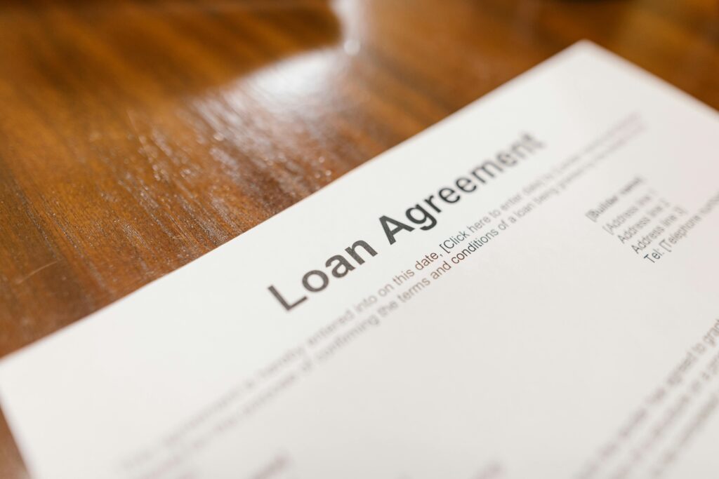 Close-up of a loan agreement document on a wooden table, highlighting the importance of understanding terms when refinancing your mortgage in Victoria, Australia.